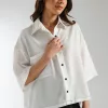 "Women's white boxy fit shirt with front pocket and black contrast stitching – trendy button-down viscose top for day events"