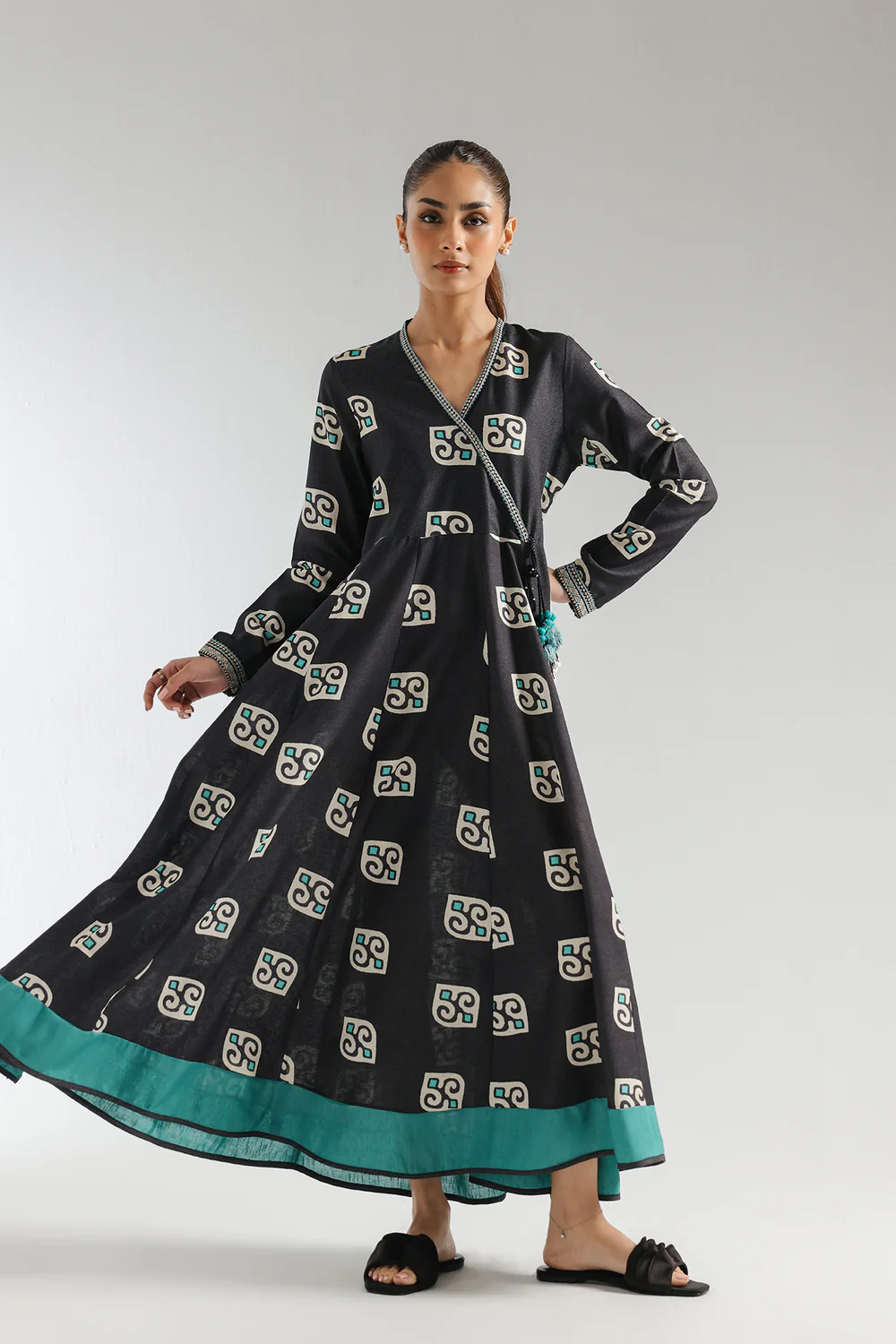 "Women's black angrakha-style pishwas in slub karandi with turquoise and white print, embroidery on neckline and sleeves, and dori tassels – 1-piece traditional formal outfit"
