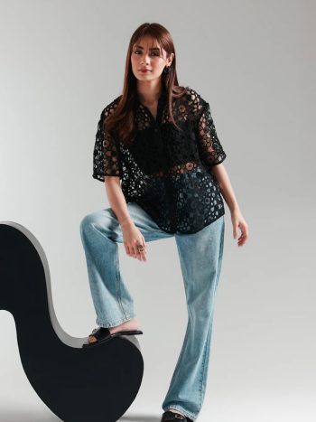 Front view of black cutwork net button-down women’s top
