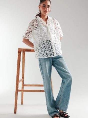 Model wearing white cutwork short sleeve button-down top