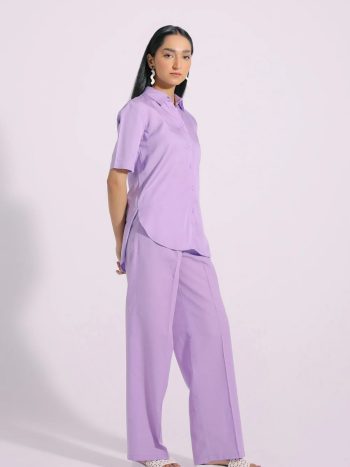 Side view showing relaxed fit and curved bottom of pastel shirt