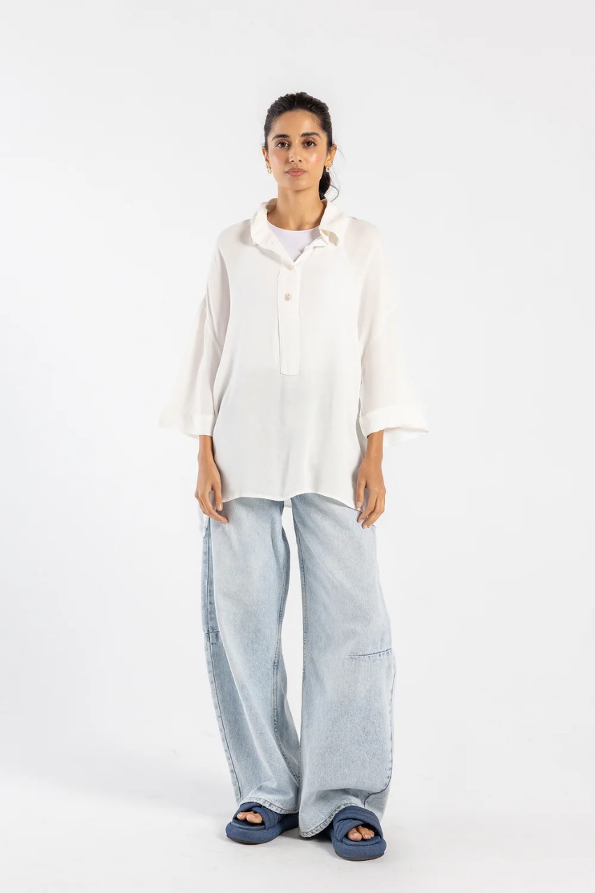 Model wearing white button-down shirt in viscose linen
