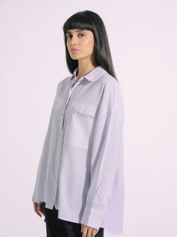 Model wearing grey striped button-down shirt with beaded pocket