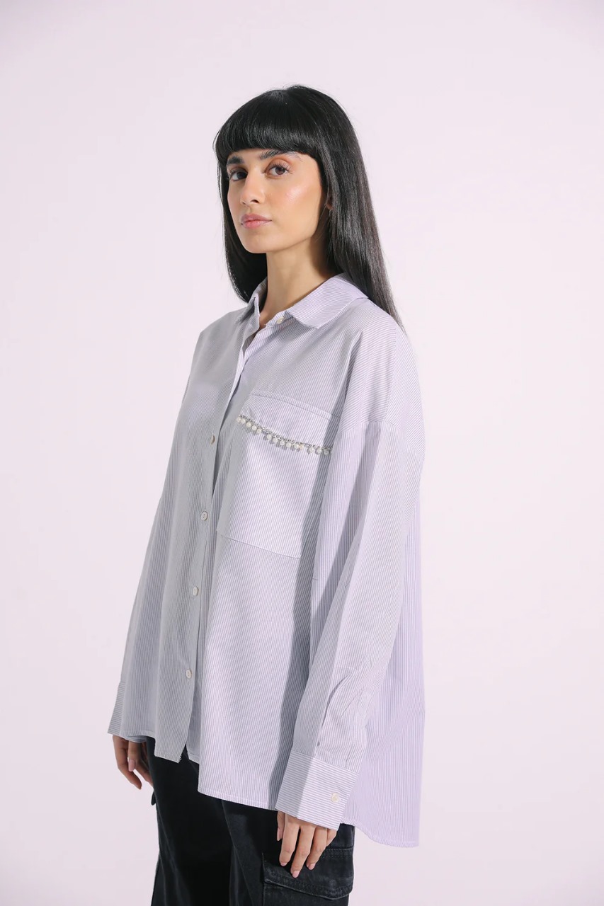 Model wearing grey striped button-down shirt with beaded pocket