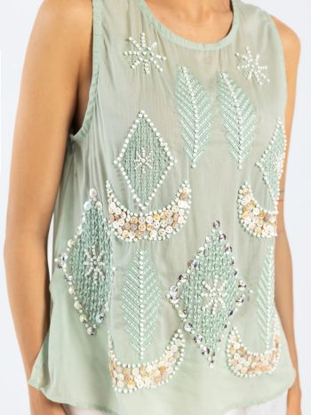 Close-up of embroidery and bead details on aqua kurti