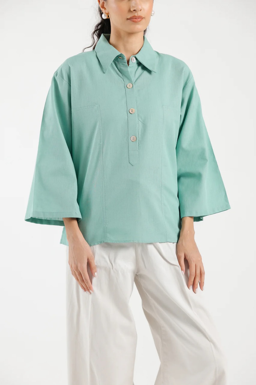 Close-up of collar and buttons on women’s sea green shirt